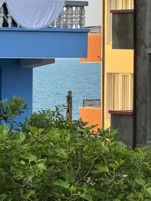 a statue standing on top of a building near the water at Studio by the sea in Primorsko