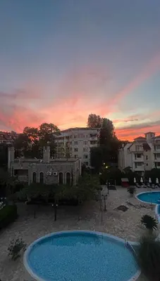 a view of two swimming pools at sunset at Kalia D11 Słoneczny Brzeg Sunny Beach in Sunny Beach