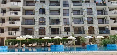 a hotel with a swimming pool in front of a building at Kalia D11 Słoneczny Brzeg Sunny Beach in Sunny Beach