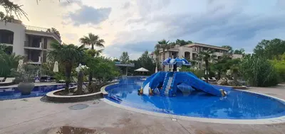 a water slide in the middle of a swimming pool at Kalia D11 Słoneczny Brzeg Sunny Beach in Sunny Beach