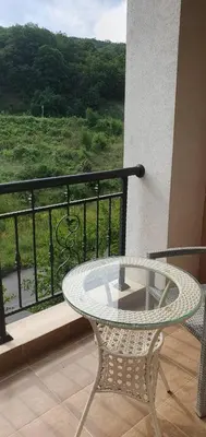 a glass table and a chair on a balcony at Квартира студия Villa Astoria 2 Болгария Солнечный берег in Elenite