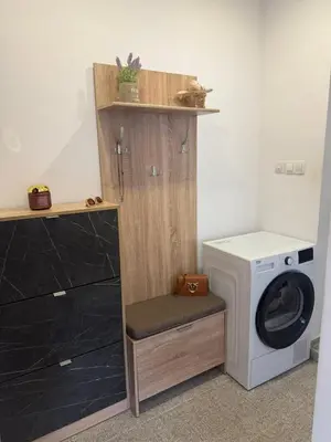 a laundry room with a washing machine and a washer at Lazzuro 7 in Burgas City