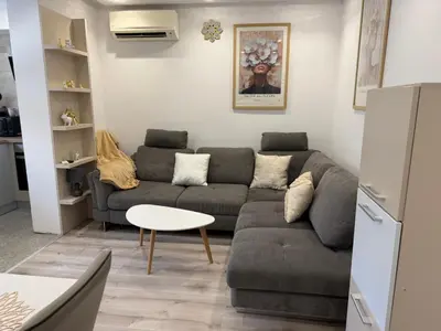 a living room with a couch and a table at Lazzuro 7 in Burgas City