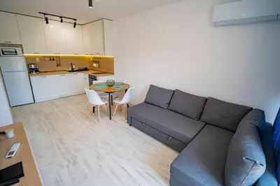 a living room with a couch and a table at Next to Harmanite Beach - 1 BD Flat with Own Parking spot by Flat Mаnager in Sozopol