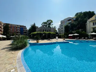 a large blue swimming pool with buildings in the background at KALIA C2 Two Bedroom Apartment Sunny Beach in Sunny Beach