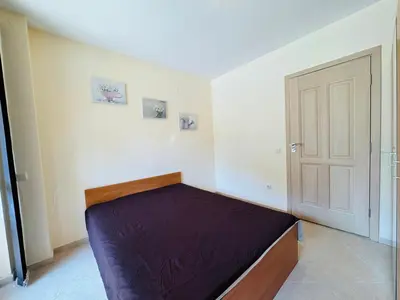 a bedroom with a bed and a door at KALIA C2 Two Bedroom Apartment Sunny Beach in Sunny Beach