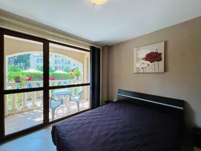 a bedroom with a bed and a view of a balcony at KALIA C2 Two Bedroom Apartment Sunny Beach in Sunny Beach