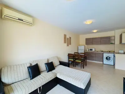 a living room with a couch and a kitchen at KALIA C4 One Bedroom Apartment Sunny Beach in Sunny Beach