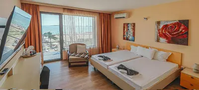 a hotel room with a bed and a view of the ocean at Sunny Beach Vila in Sunny Beach