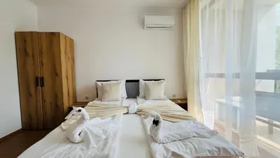 two swans are sitting on two beds in a room at ASTORIA II Apartment 54 One Bedroom in Elenite
