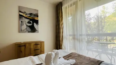 a bedroom with a bed and a window and a table at ASTORIA II Apartment 24 One Bedroom in Elenite