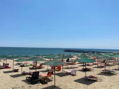 a beach with chairs and umbrellas and the ocean at ASTORIA II Apartment 13 One Bedroom Parter in Elenite