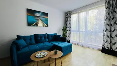a living room with a blue couch and a table at ASTORIA II Apartment 23 One Bedroom in Elenite