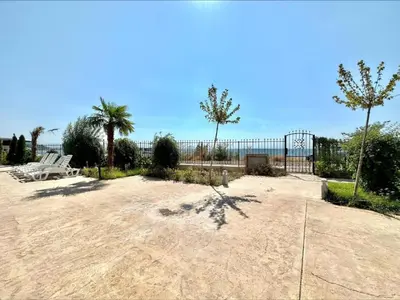 a sandy area with a volley ball hoop and palm trees at Ipanema Beach - new - luxury first line - sea view in Sveti Vlas