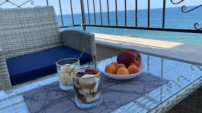 a bowl of fruit on a table on a balcony at Ipanema Beach - new - luxury first line - sea view in Sveti Vlas