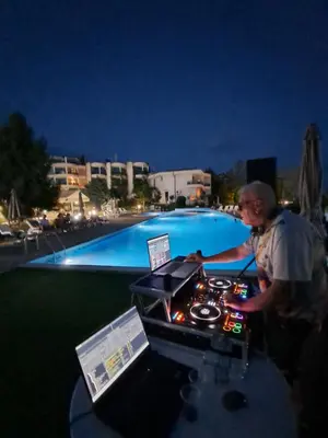 a man standing at a table in front of a pool at Yacht Port apartment #sea view# in Sveti Vlas