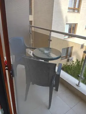 a glass table and a chair on a balcony at Студио във Виго Панорама Несебър in Nesebar