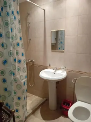a bathroom with a sink and a toilet and a shower at Студио във Виго Панорама Несебър in Nesebar