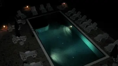 an overhead view of a swimming pool and chairs at night at High in the Sky Apartments in Sozopol