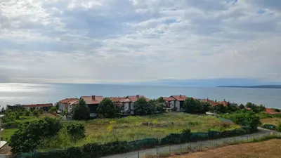 a row of houses on a hill next to the ocean at High in the Sky Apartments in Sozopol