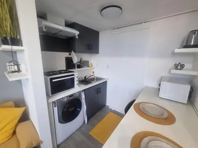 a kitchen with a washing machine in a small room at Roman panorama - Varna in Varna City