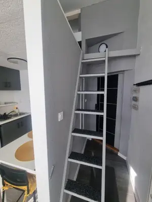 a spiral staircase in a kitchen with a table at Roman panorama - Varna in Varna City