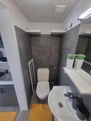 a small bathroom with a toilet and a sink at Roman panorama - Varna in Varna City