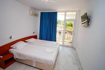 a bedroom with a bed and a large window at Harmani Haven 1BD Apartment with Own Parking spot by Flat Manаger in Sozopol