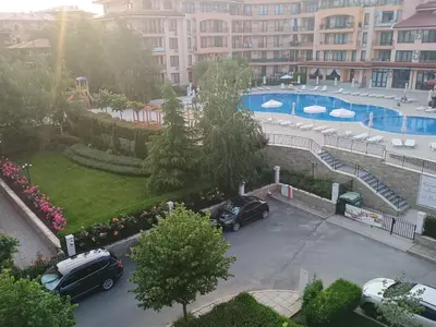 two cars parked in a parking lot with a pool at Sky dreams Sveti Vlas in Sveti Vlas