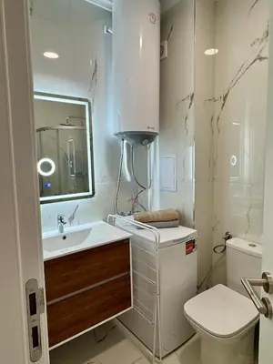 a bathroom with a sink and a toilet and a mirror at Domenico Luxury Apartments in Sunny Beach