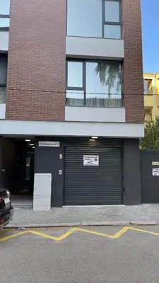 a building with a garage door with a sign on it at Тони апартмент in Burgas City