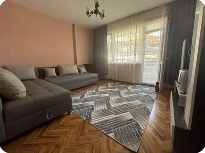 a living room with a couch and a tv at Anastasiya's Flat in Pomorie