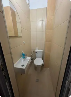 a small bathroom with a toilet and a sink at Anastasiya's Flat in Pomorie