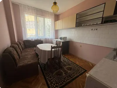 a living room with a table and a couch at Anastasiya's Flat in Pomorie