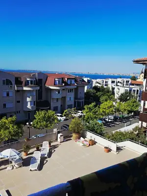 a view of a patio with chairs and buildings at Апартамент Кара миа in Sveti Vlas