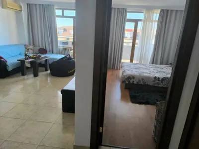a room with a living room with a bed and a couch at Апартамент Кара миа in Sveti Vlas