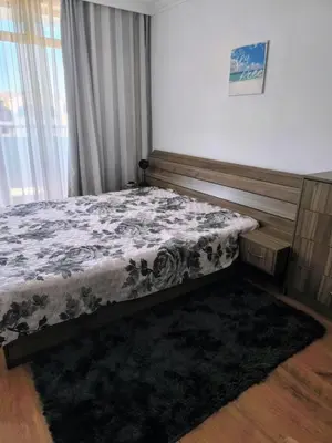 a bedroom with a bed and a window at Апартамент Кара миа in Sveti Vlas