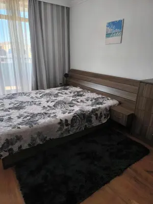 a bedroom with a bed and a window at Апартамент Кара миа in Sveti Vlas