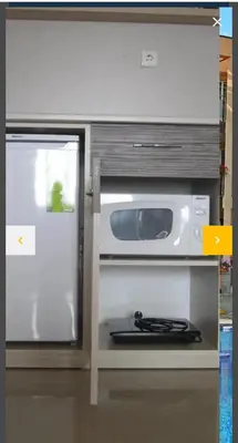 a refrigerator with its door open next to a microwave at Sozopoli Hills A-17 sea view in Sozopol
