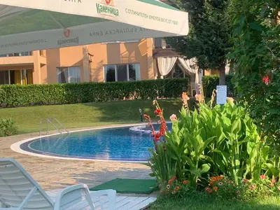 a swimming pool in a yard with chairs and an umbrella at Sozopoli Hills A-17 sea view in Sozopol