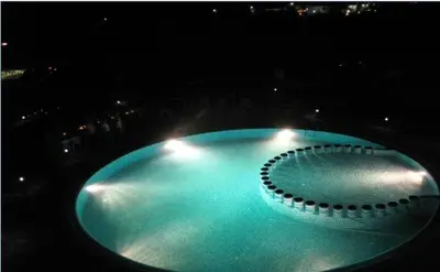 a large blue pool with lights in the dark at Sozopoli Hills A-17 sea view in Sozopol