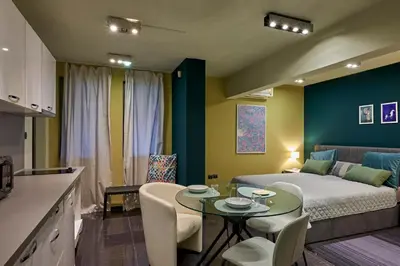a living room with a bed and a table with chairs at Beauty 1 FREE PARKING in Burgas City