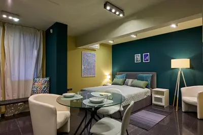 a bedroom with a bed and a table and chairs at Beauty 1 FREE PARKING in Burgas City