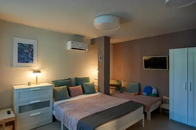 a bedroom with a bed and a dresser in it at Beauty 2 FREE PARKING in Burgas City
