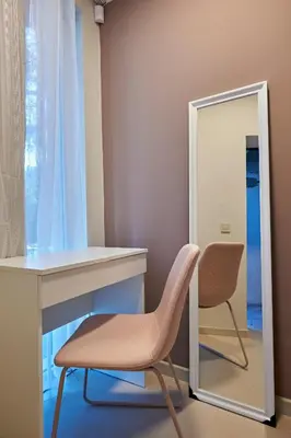 a dressing room with a chair and a mirror at Beauty 2 FREE PARKING in Burgas City