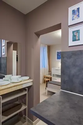 a room with a bed and a table with plates at Beauty 2 FREE PARKING in Burgas City