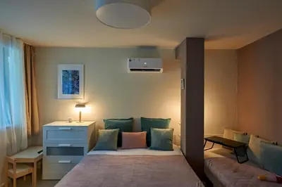 a bedroom with a bed and a couch at Beauty 2 FREE PARKING in Burgas City
