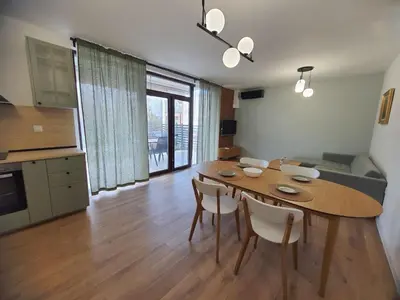 a kitchen and dining room with a table and chairs at Вила Фамилия - Villa Family in Lozenets