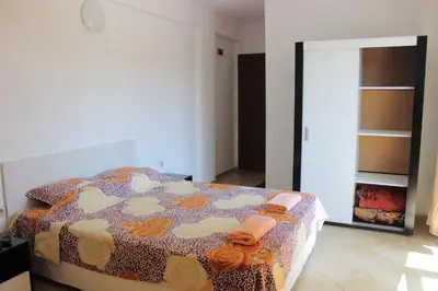 a bedroom with a bed in a room with a mirror at Tangra Guest House in Arapya