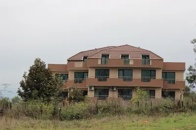 a building in the middle of a field at Tangra Guest House in Arapya
